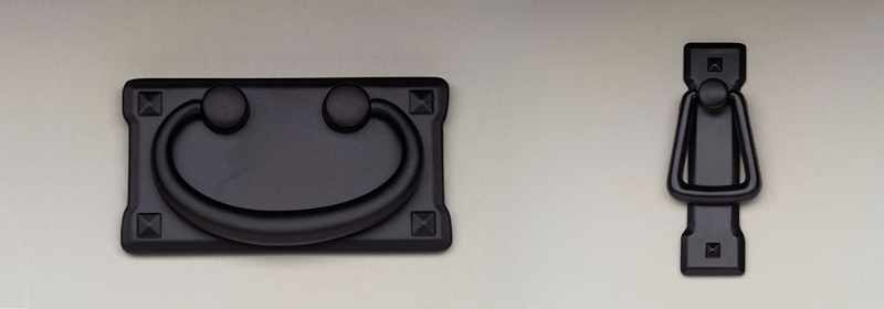 Smooth finish black metal door and drawer pulls.