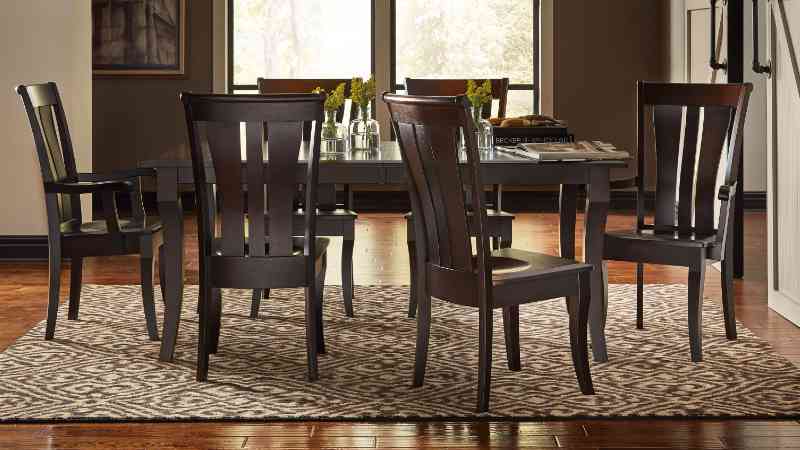 Beveled edge dining table with chairs.