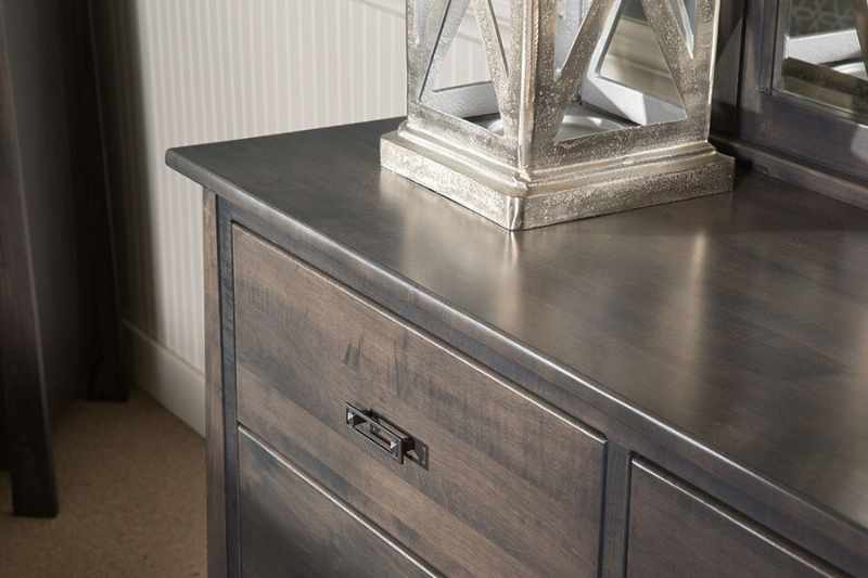 Top of a dresser finished with a dark stain.