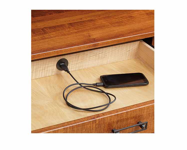 Detail view of open desk drawer with built-in USB hub.