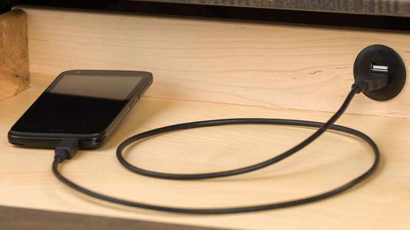 Detail view of built-in USB hub, shows plugged in smart phone.