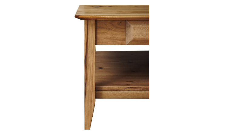 Detail view of solid wood coffee table tapered leg.