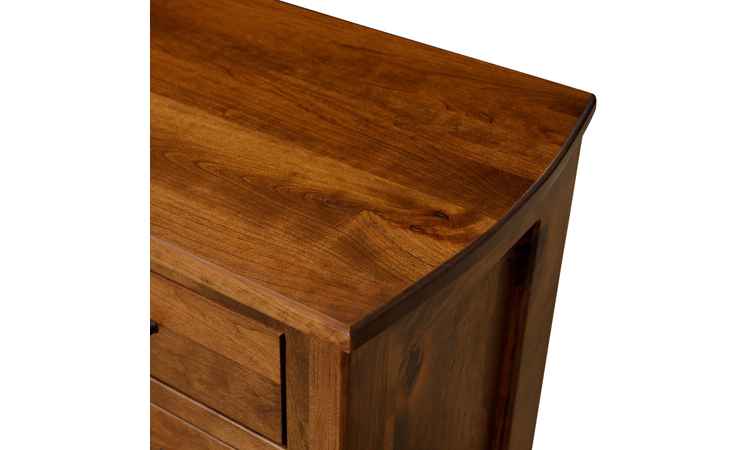 Closeup view of dresser top with curved edge.