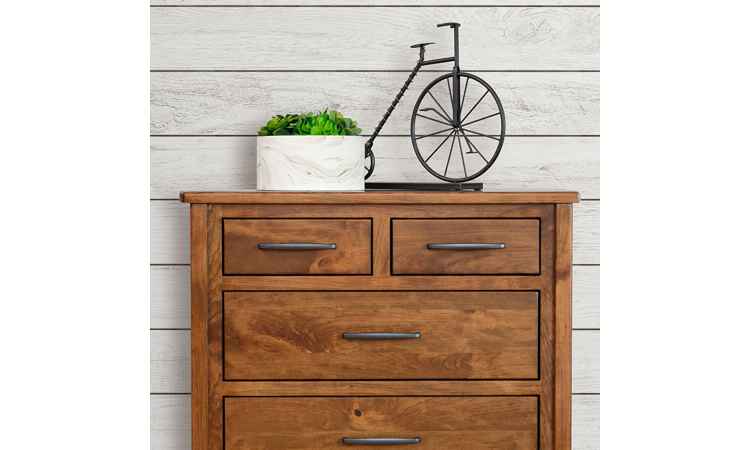 Closeup view of Chest of Drawers positioned against a wall, decorated with a planter.
