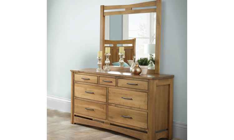 Dresser with mirror positioned against wall, decorated with candle sticks.