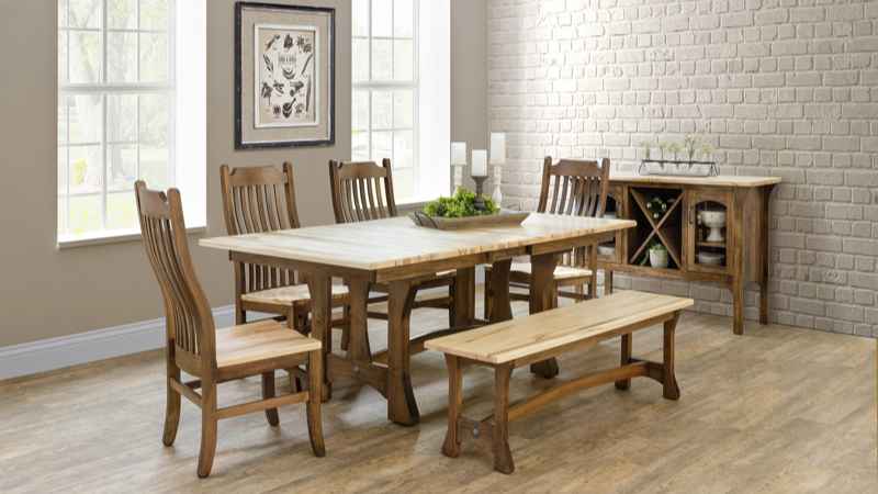 Dining table with 4 chairs and bench in room setting.